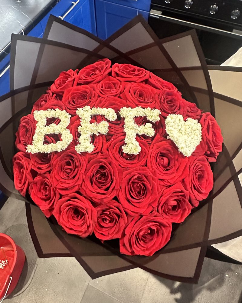 Red rose bouquet in black wrap with BFF and a heart written in gypsophila