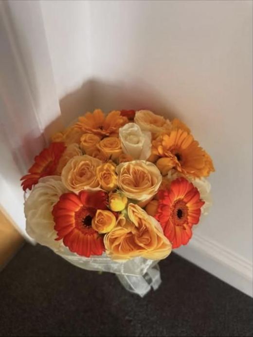 Orange gerberas with peach, yellow and cream roses